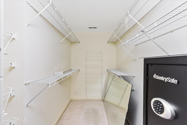 spacious closet with carpet floors and visible vents
