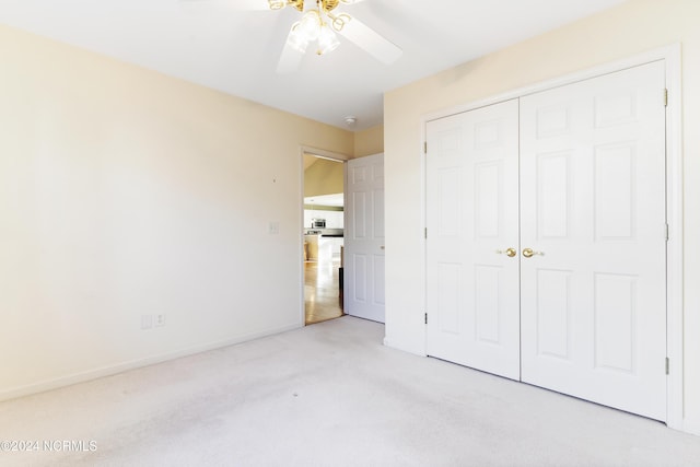 unfurnished bedroom featuring baseboards, ceiling fan, carpet, and a closet