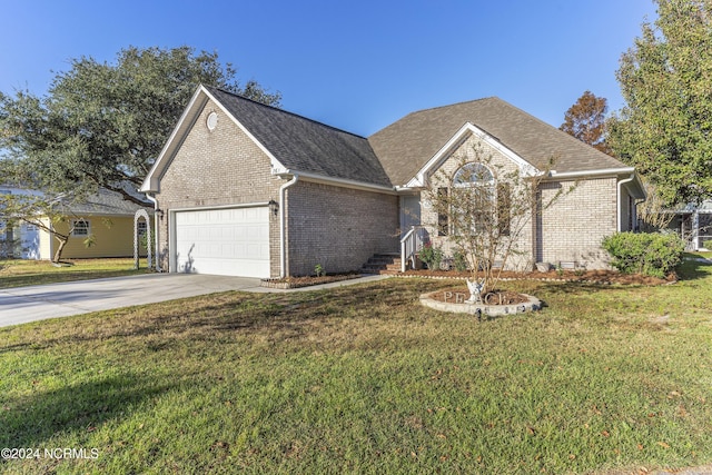 view of front of property with brick siding, a front lawn, an attached garage, and driveway
