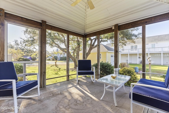 sunroom featuring ceiling fan