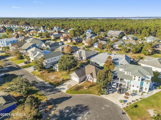 bird's eye view featuring a wooded view and a residential view