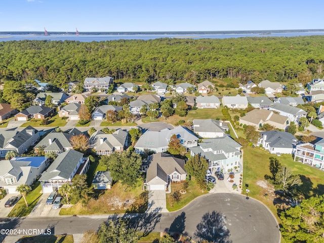 birds eye view of property with a residential view, a water view, and a wooded view