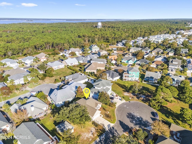 birds eye view of property featuring a forest view and a residential view