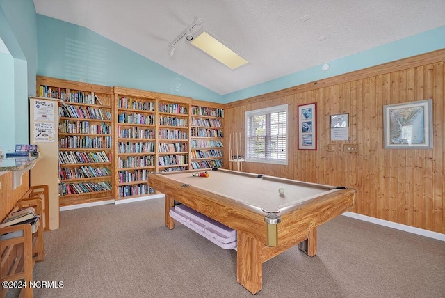 game room featuring track lighting, wood walls, carpet, and lofted ceiling