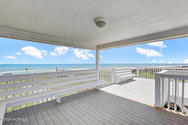 wooden deck with a view of the beach and a water view