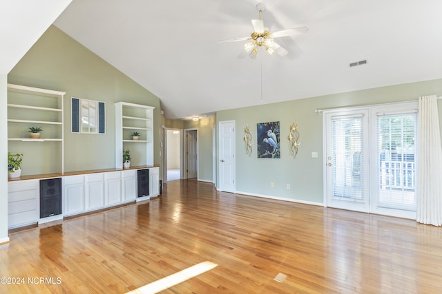 unfurnished living room with ceiling fan, visible vents, light wood finished floors, and high vaulted ceiling