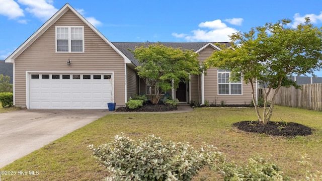 view of front facade featuring an attached garage, fence, driveway, and a front lawn