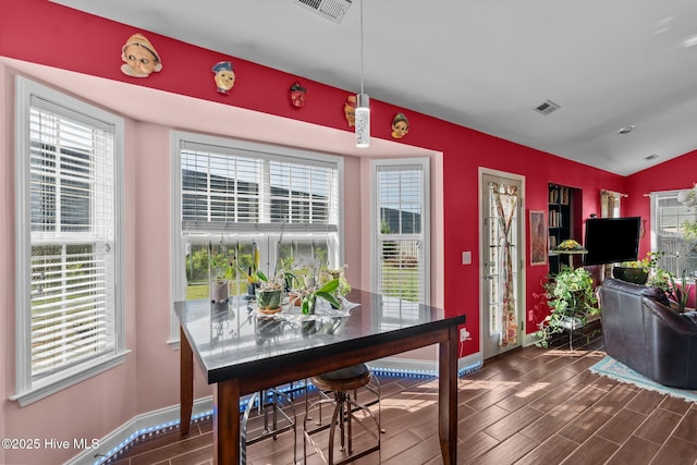 dining space with visible vents, baseboards, and dark wood finished floors