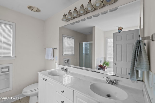 full bathroom with visible vents, a sink, a stall shower, and toilet