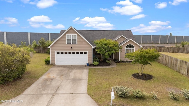 traditional-style house featuring an attached garage, fence, a front yard, and concrete driveway