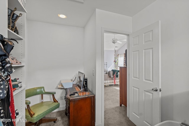 interior space with a ceiling fan and carpet