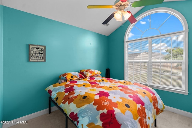 carpeted bedroom with a ceiling fan, baseboards, and lofted ceiling