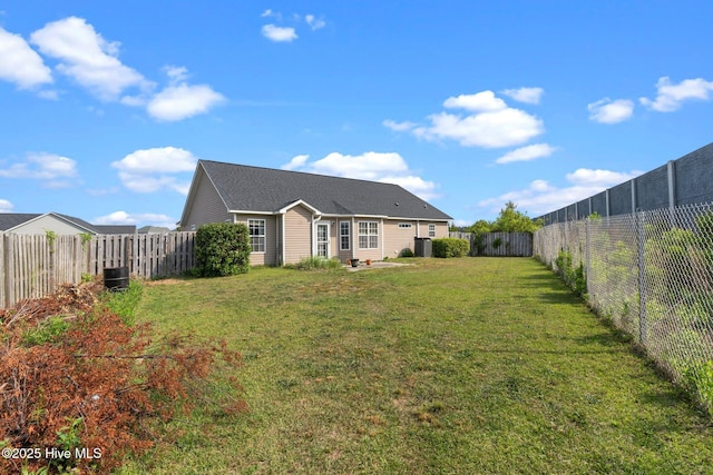 exterior space featuring a lawn, a fenced backyard, and cooling unit