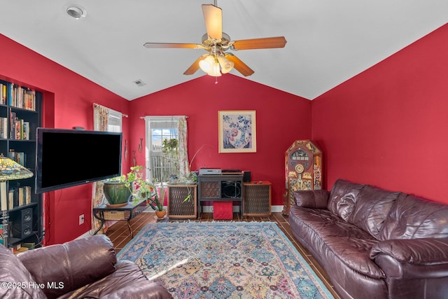 living room featuring baseboards, visible vents, a ceiling fan, and lofted ceiling