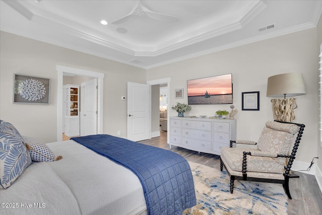 419 Glenn Ellen Dr, Wilmington, NC 28412 - bedroom featuring ceiling fan, visible vents, crown molding, wood finished floors, and a tray ceiling