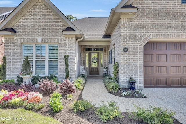 419 Glenn Ellen Dr, Wilmington, NC 28412 - doorway to property with a shingled roof, an attached garage, and brick siding