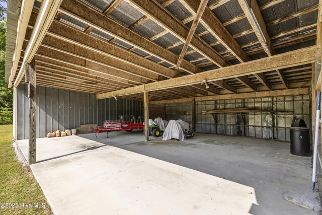 miscellaneous room featuring unfinished concrete flooring and a garage