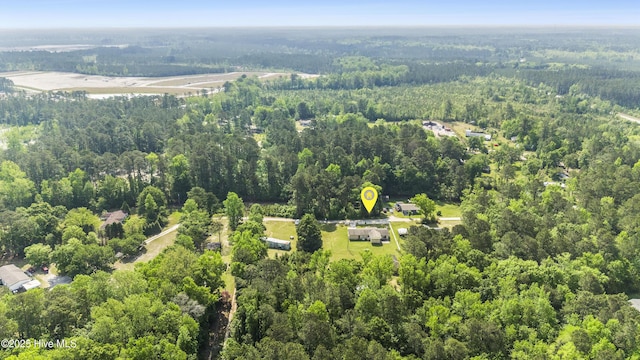 birds eye view of property featuring a view of trees