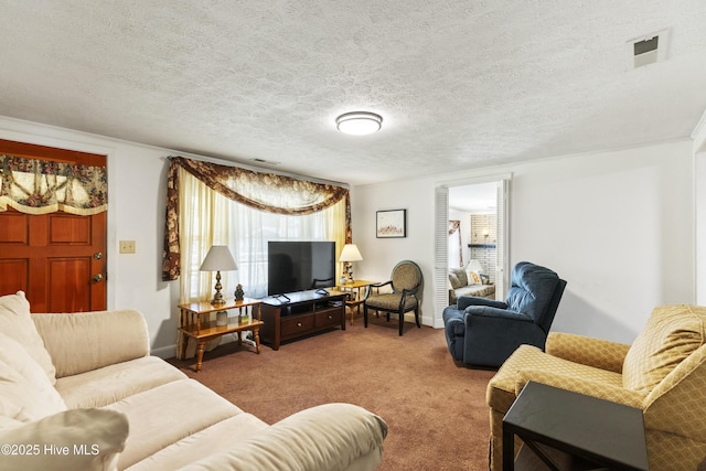 living room featuring a textured ceiling, visible vents, and carpet