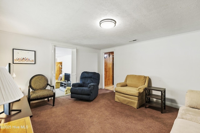 carpeted living room featuring a textured ceiling and visible vents