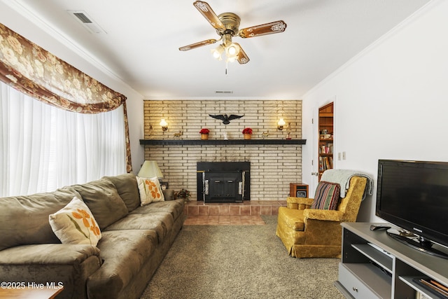 living area featuring ceiling fan, visible vents, a fireplace, ornamental molding, and carpet