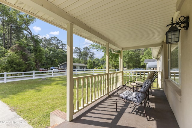 view of patio / terrace with fence and covered porch
