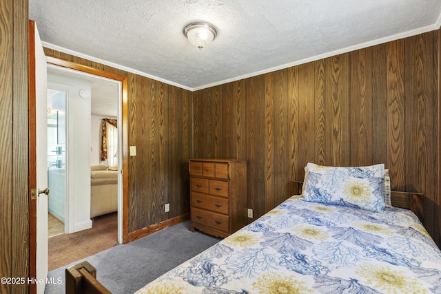 carpeted bedroom featuring a textured ceiling, wood walls, and baseboards