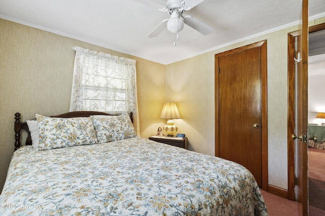 bedroom with crown molding, carpet, and a ceiling fan