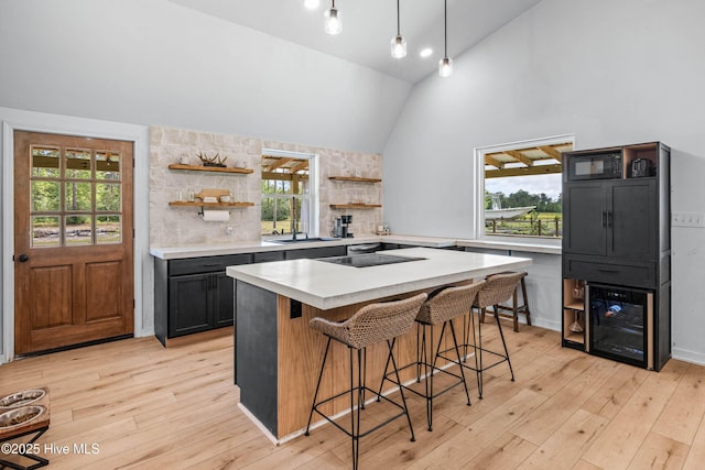 500 Tomahawk Rd, Maple Hill, NC 28454 - kitchen with open shelves, beverage cooler, light countertops, a kitchen breakfast bar, and plenty of natural light