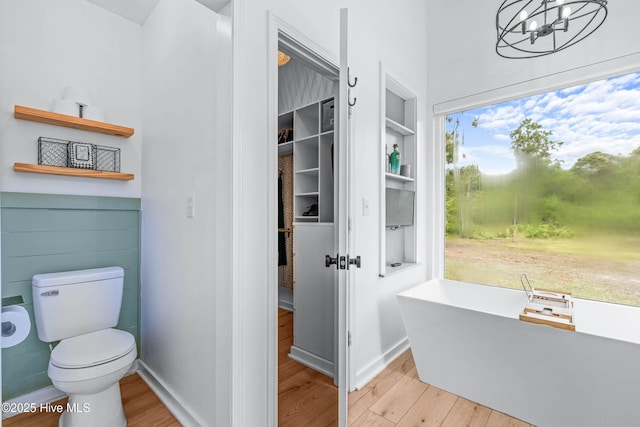 500 Tomahawk Rd, Maple Hill, NC 28454 - bathroom with wood finished floors, a chandelier, toilet, a soaking tub, and built in features
