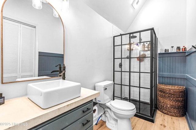 500 Tomahawk Rd, Maple Hill, NC 28454 - bathroom featuring wood finished floors, a stall shower, vaulted ceiling, vanity, and toilet