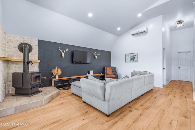 500 Tomahawk Rd, Maple Hill, NC 28454 - living area featuring a wall mounted AC, lofted ceiling, light wood finished floors, baseboards, and a wood stove