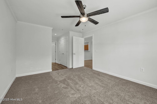 unfurnished bedroom with baseboards, ornamental molding, and carpet floors