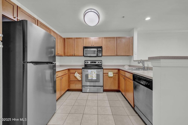 kitchen with light tile patterned floors, ornamental molding, a sink, light countertops, and appliances with stainless steel finishes