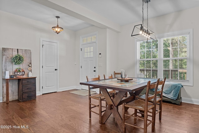 27 Pine Lake Dr, Whispering Pines, NC 28327 - dining space with dark wood-style flooring, baseboards, and a chandelier