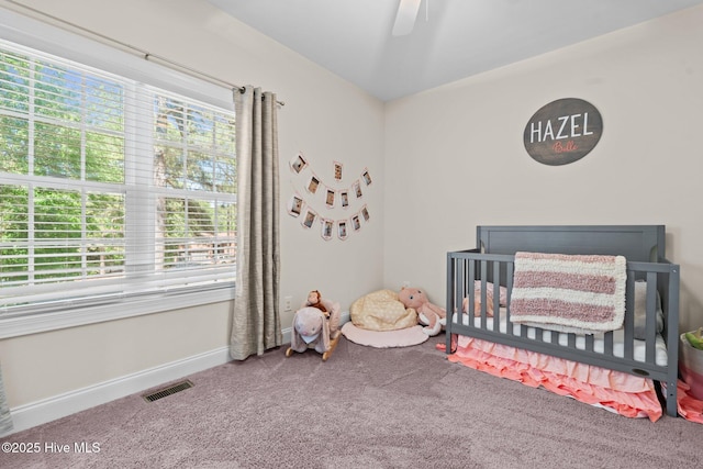 27 Pine Lake Dr, Whispering Pines, NC 28327 - bedroom with carpet flooring, a crib, baseboards, and a ceiling fan