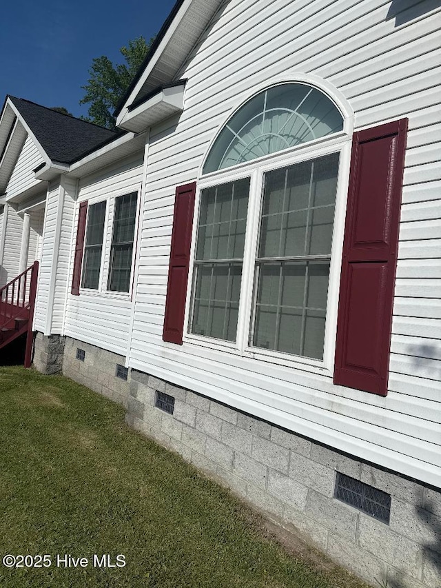 view of property exterior with a yard and crawl space
