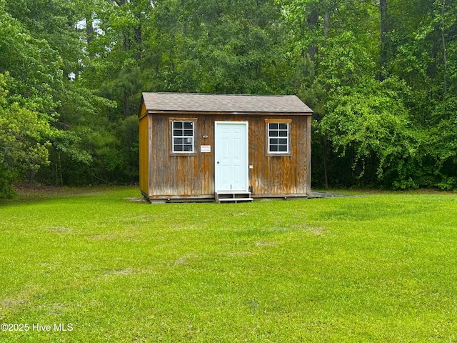 view of shed with a wooded view