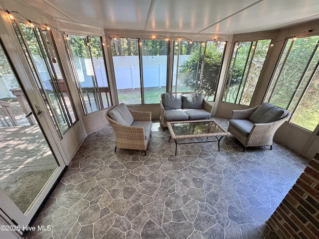 sunroom featuring outdoor lounge area