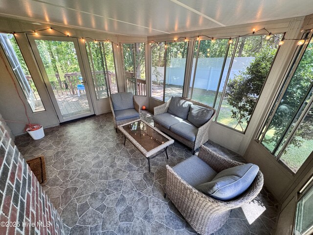 sunroom with plenty of natural light and an outdoor living space