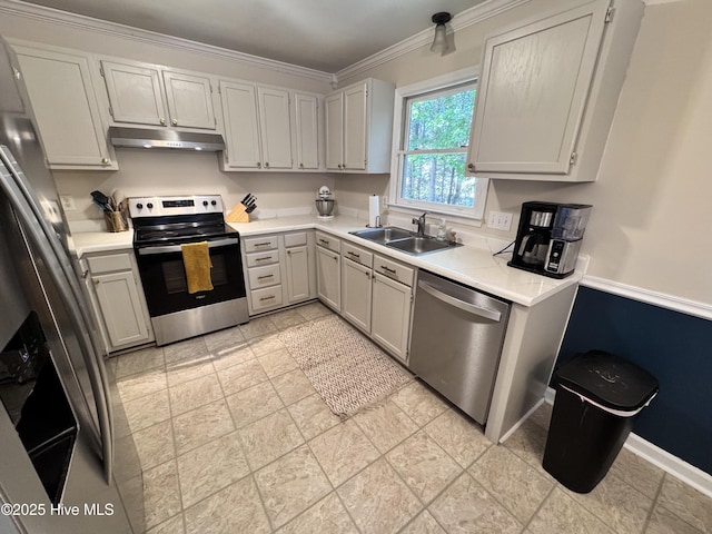 kitchen with crown molding, light countertops, under cabinet range hood, a sink, and appliances with stainless steel finishes