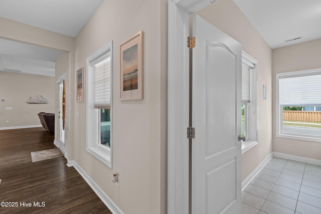 hallway with baseboards and wood finished floors