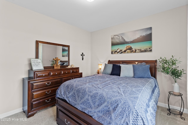 bedroom featuring light colored carpet and baseboards