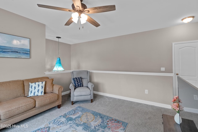 sitting room with carpet, a ceiling fan, and baseboards