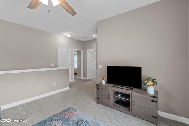 carpeted living room featuring ceiling fan and baseboards