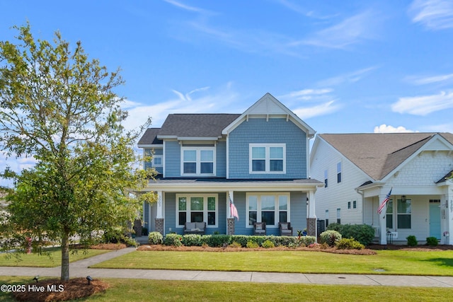 craftsman-style house with a porch and a front lawn