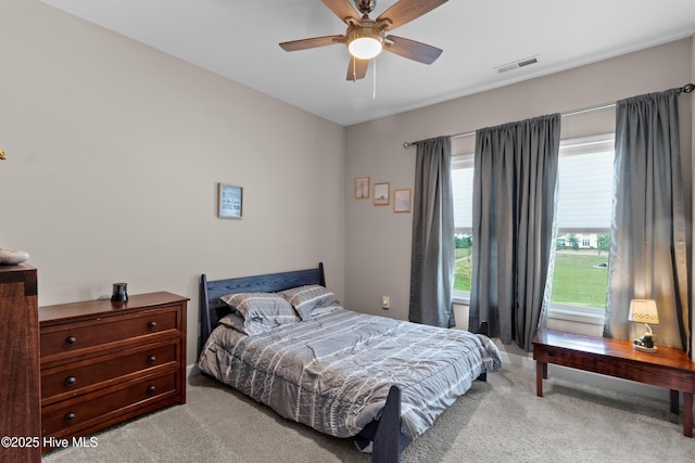 bedroom with light colored carpet and a ceiling fan