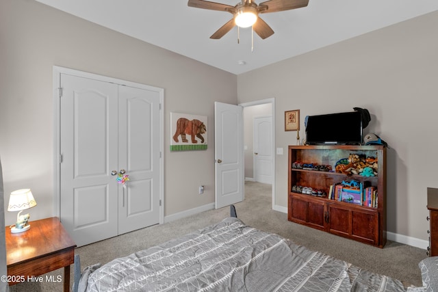 carpeted bedroom with baseboards, ceiling fan, and a closet