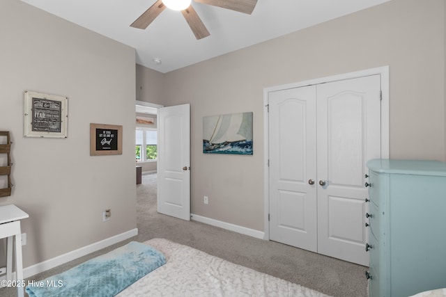 bedroom with carpet flooring, a closet, baseboards, and a ceiling fan