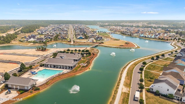 aerial view of property's location featuring nearby suburban area, a pool, and a nearby body of water